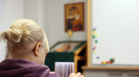 Girl is reading Bible.