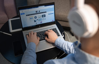 Mies suorittaa projektiasiantuntijuuden opintoja tietokoneella.