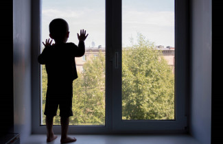 Lapsi katsoo ulos ikkunasta