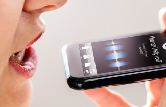 Woman using the voice recognition of a mobile phone.