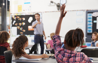 Teacher and pupils in classroom.