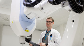 Man working on examination equipment of medical physics.