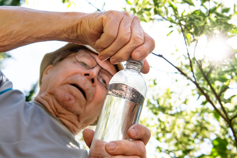 Old man drinking water.