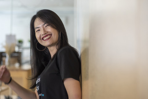 Young woman looking at the camera smiling.