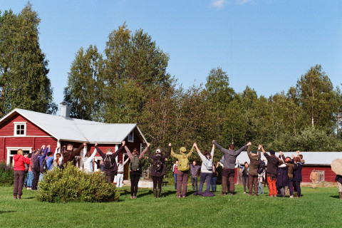 People raising hands in circle