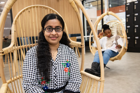 Two women sitting and smiling