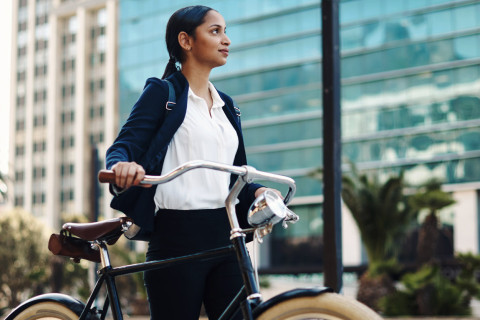 Woman pushing a bicycle.