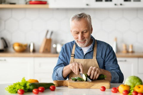 Man chopping vegetables.