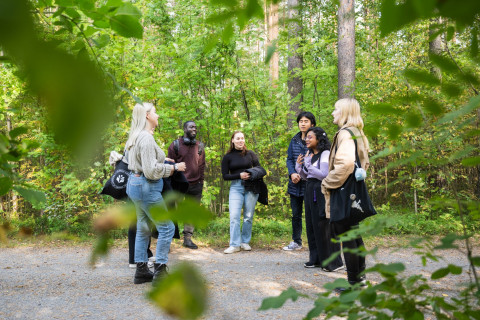 Students discussing in a group outdoors.