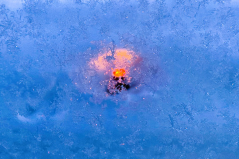 A view full of frost, with a glimpse of fire in the middle.