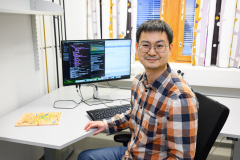 Lu Cheng working on a computor.
