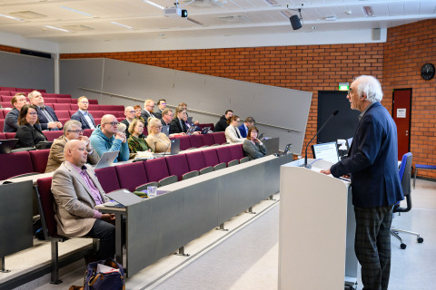 Siamäk Naghian puhumassa yleisön edessä.