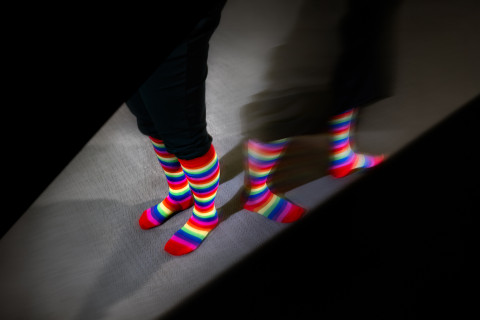A picture of pride socks that diverge in different directions.