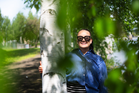 Ruotsin kielen opiskelija Riikka Kinnunen aurinkolasit päässään kesäisessä maisemassa