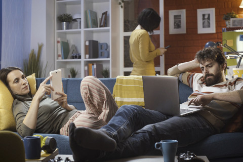 Friends connecting with their devices at home and ignoring each other, technology and lifestyle concept.