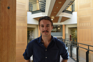Student smiling in a corridor