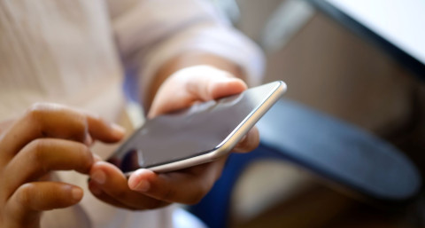 close up on man using smartphone