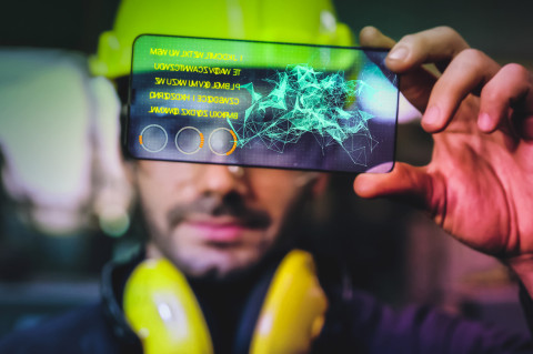 Man watching a holographic screen.