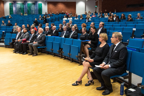 Audience. Hosts sitting in the foreground.