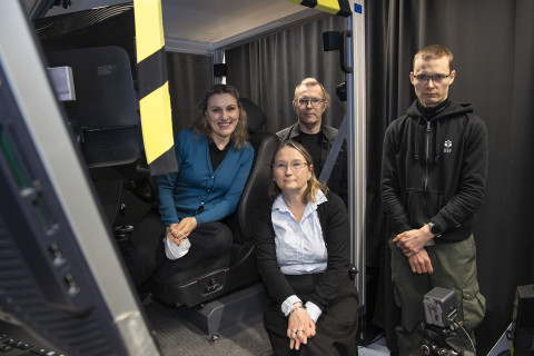 Four persons in a group photo.