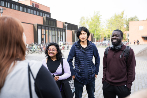 Students outside of campus, smiling