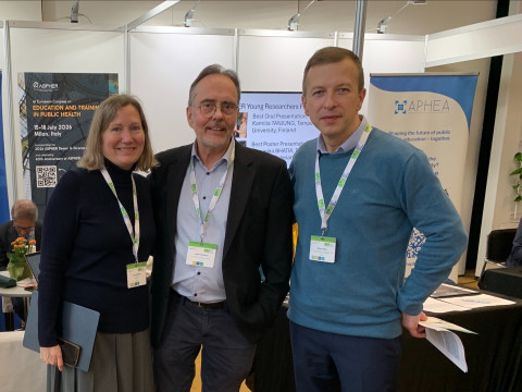 Three people standing on a fair