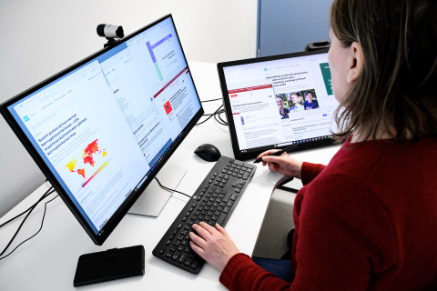 Henkilö lukee verkkoartikkeleja.