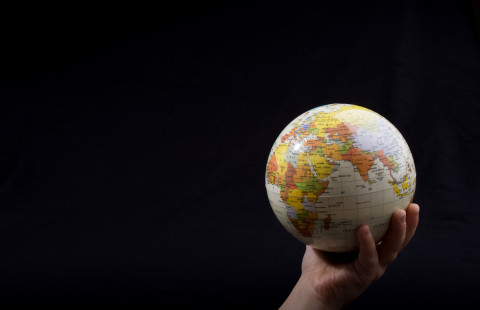 Hand holding a globe