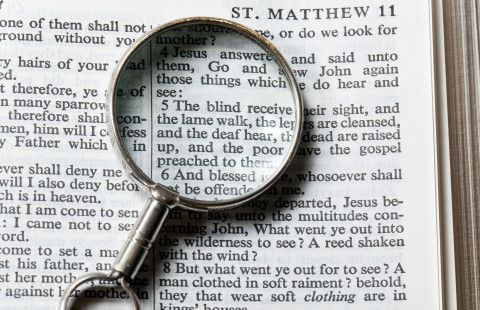 magnifying glass on a book.