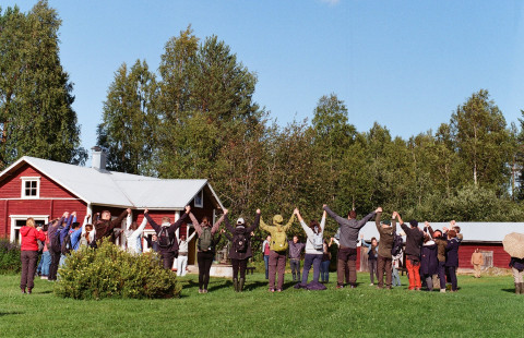 People raising hands in circle