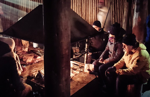 Researchers by the campfire.