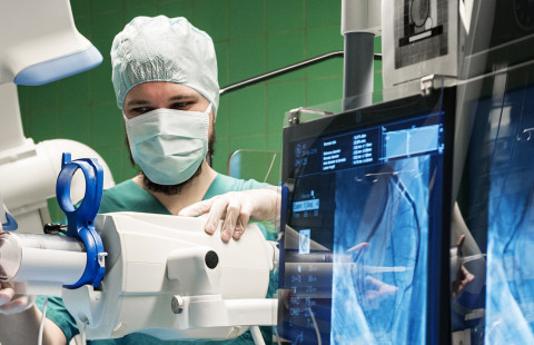 Mies työskentelee leikkaussalissa.