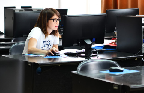 Woman working on a computer.