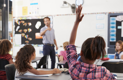 Teacher and pupils in classroom.