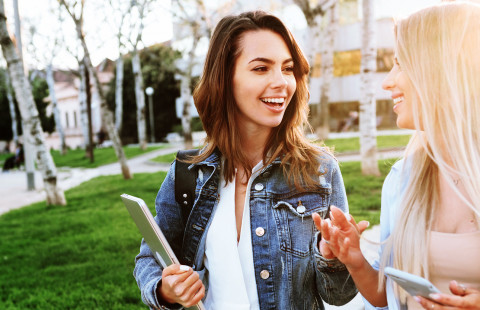 Friends talking with each other in a park.