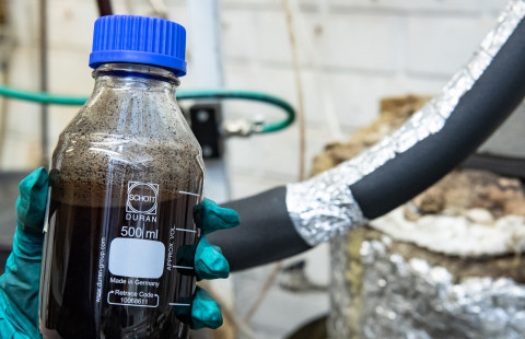 Liquid bottle in hand.