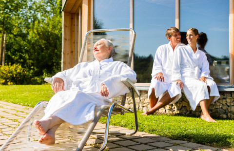 People relaxing outside sauna.