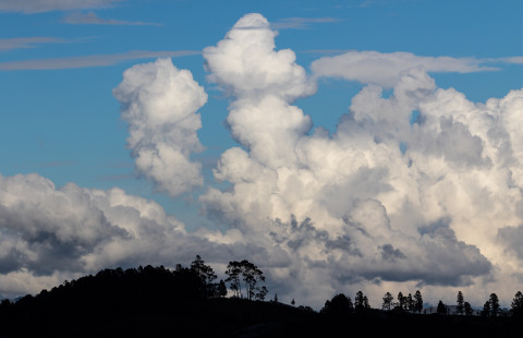 Hills and clouds on a blue sky.