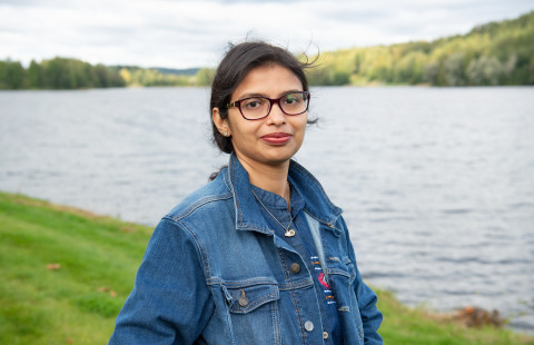Student smiling by the lake