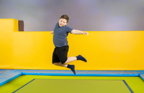 Child jumping on trampoline.