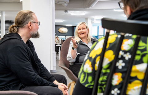 Three people having a conversation.