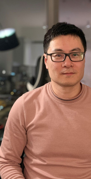 Man with glasses and dark hair looking at the camera.